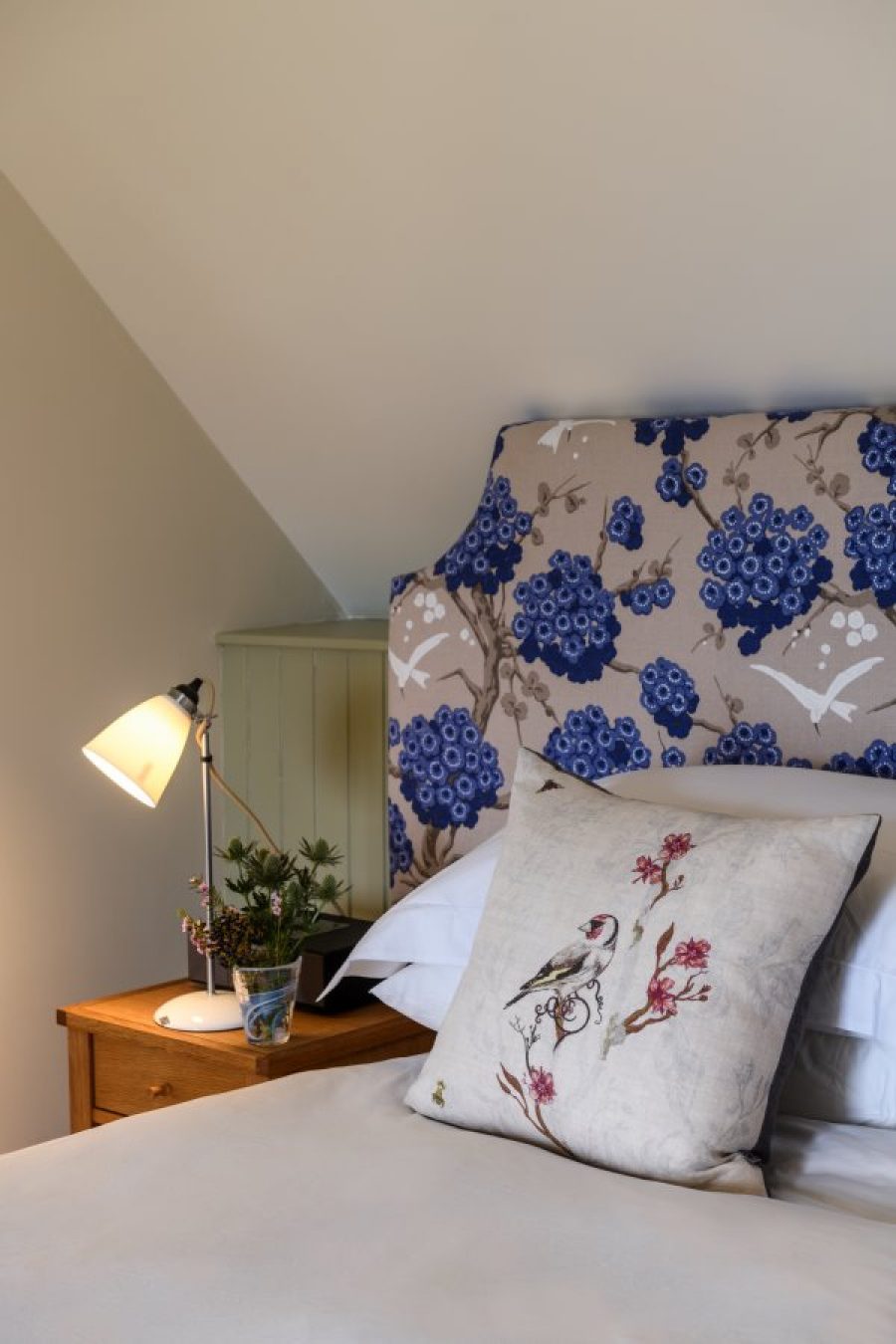 Croft House cottage. Upstairs, the bedroom has a vaulted ceiling with beams in local Douglas Fir and a super-king bed with a custom made headboard in designer linen.