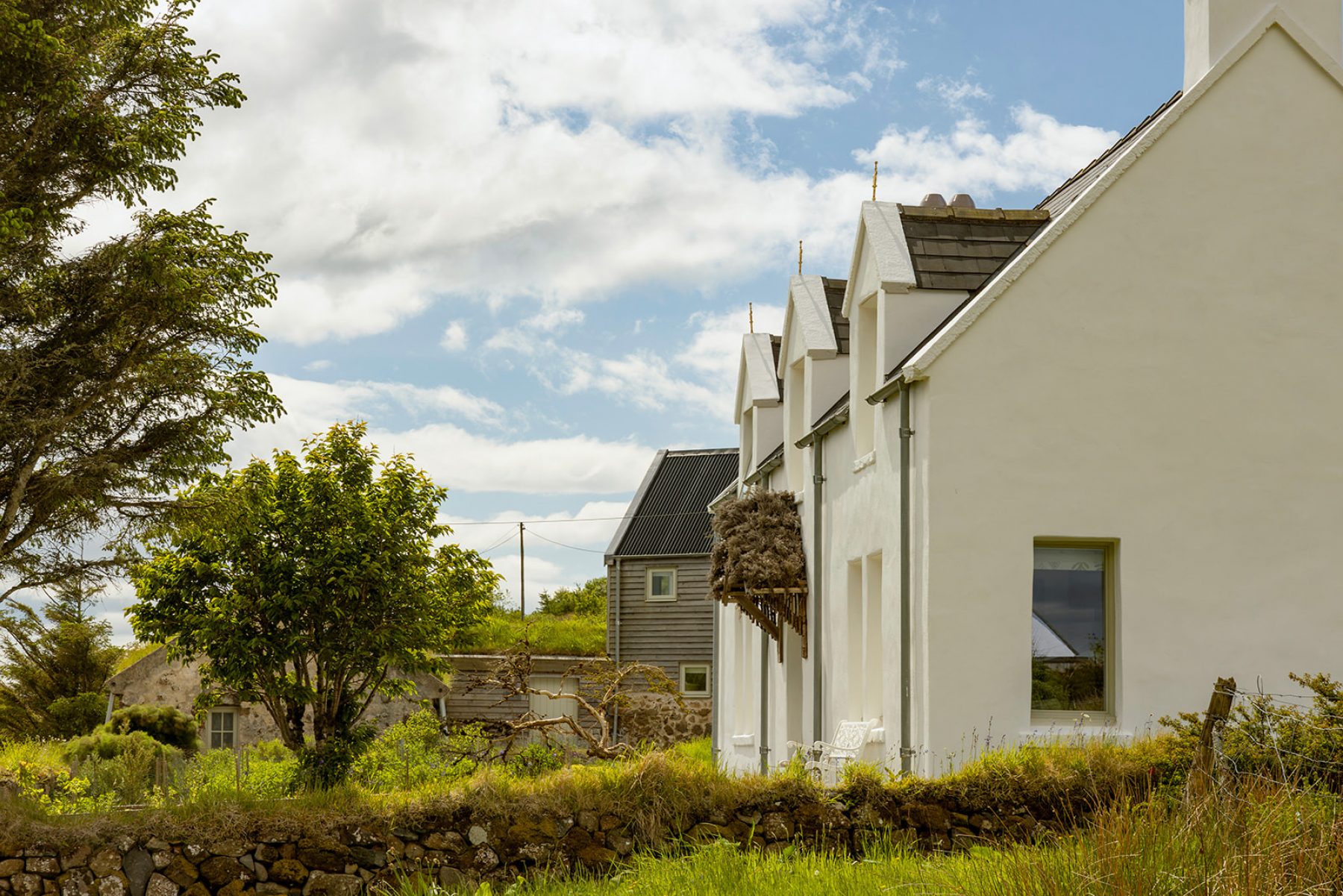 From the field beside the Croft House cottage, a traditional Highland whitewashed stone cottage at Geary, Isle of Skye.