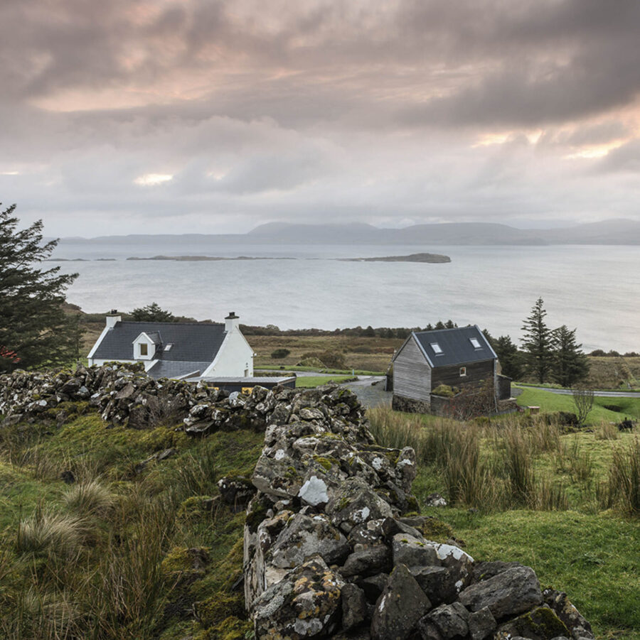 At Mint Croft Skye, croft land with dry stone wall, traditional croft buildings and a view of the sea across Loch Snizort towards the Trotternish penisula