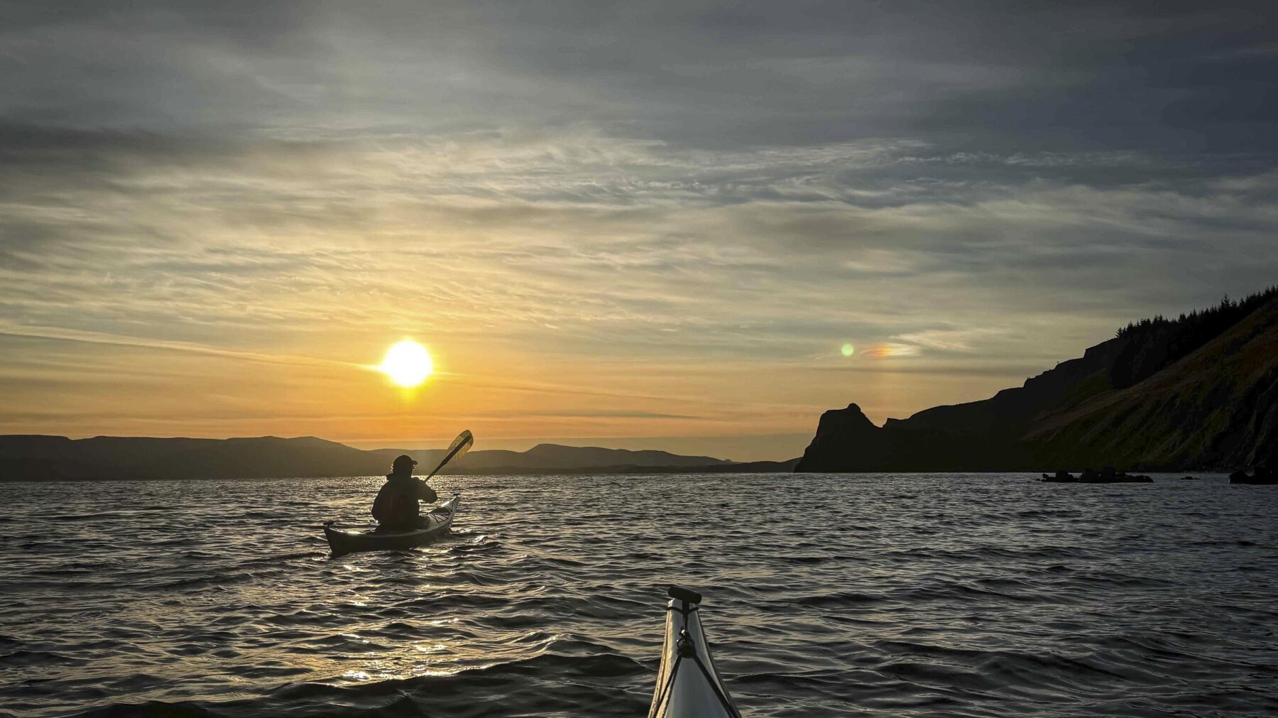 Kayaking off the Waternish peninsual, Isle of Skye in low autumn light