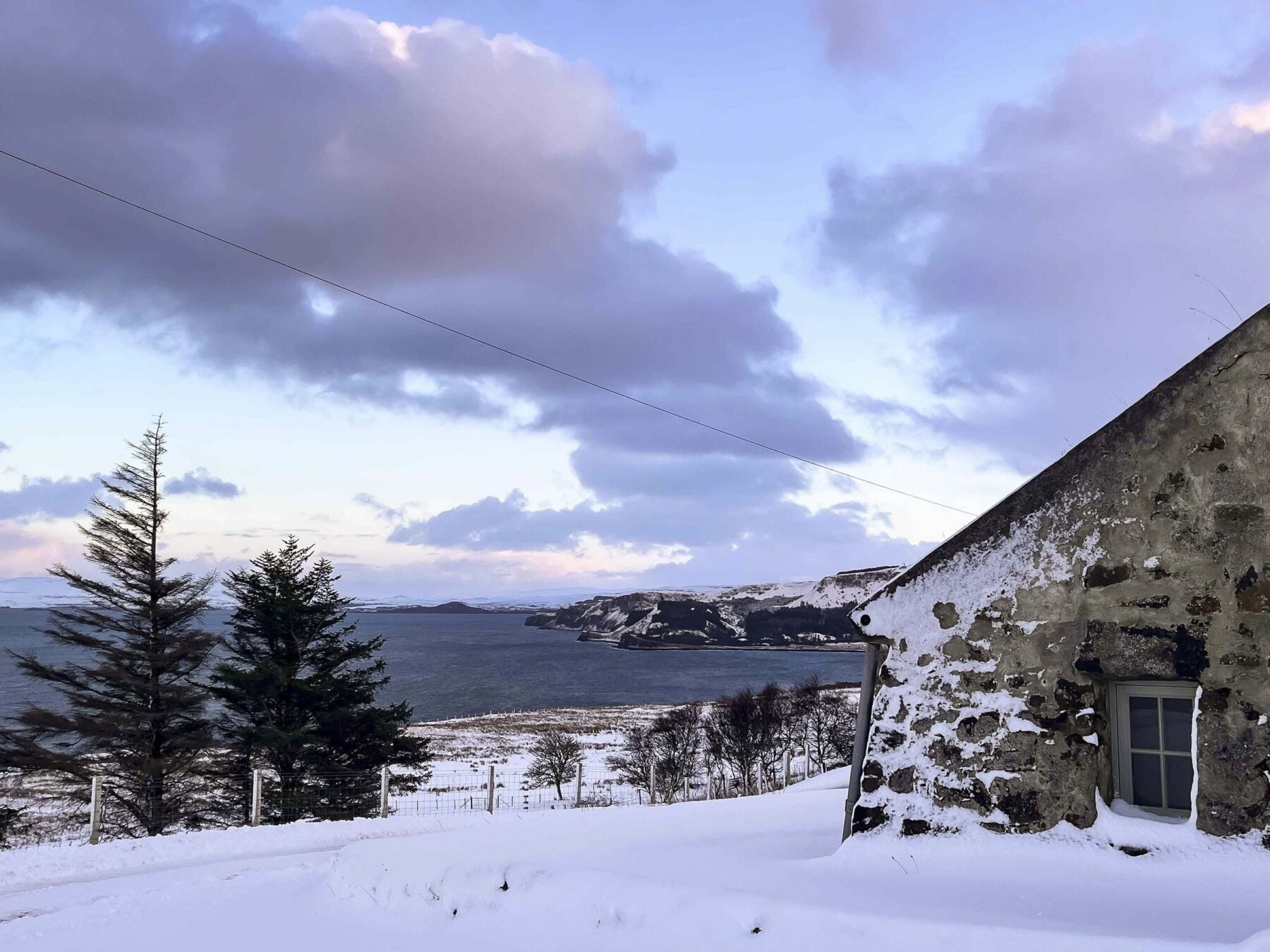 Hebridean blackhouse cottage in snow, Skye, Highlands, Scotland.