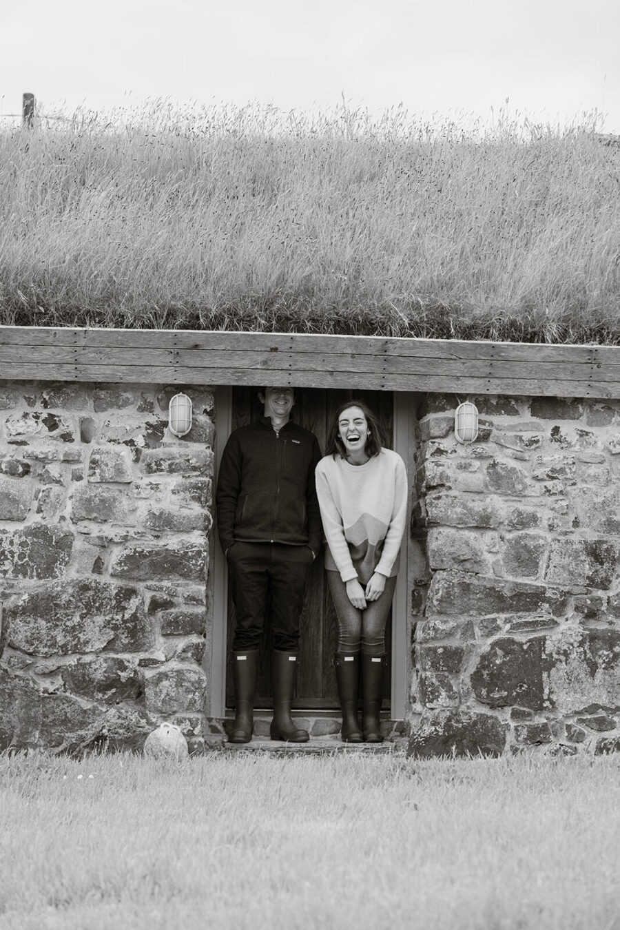 Architects James Mitchell and Carolina Larrazábal standing in the doorway at the Blackhouse, a traditional turf-roofed building at Mint Croft, Skye. The doorway is too small!